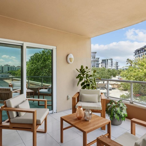 a room with a table chairs and a window with trees outside