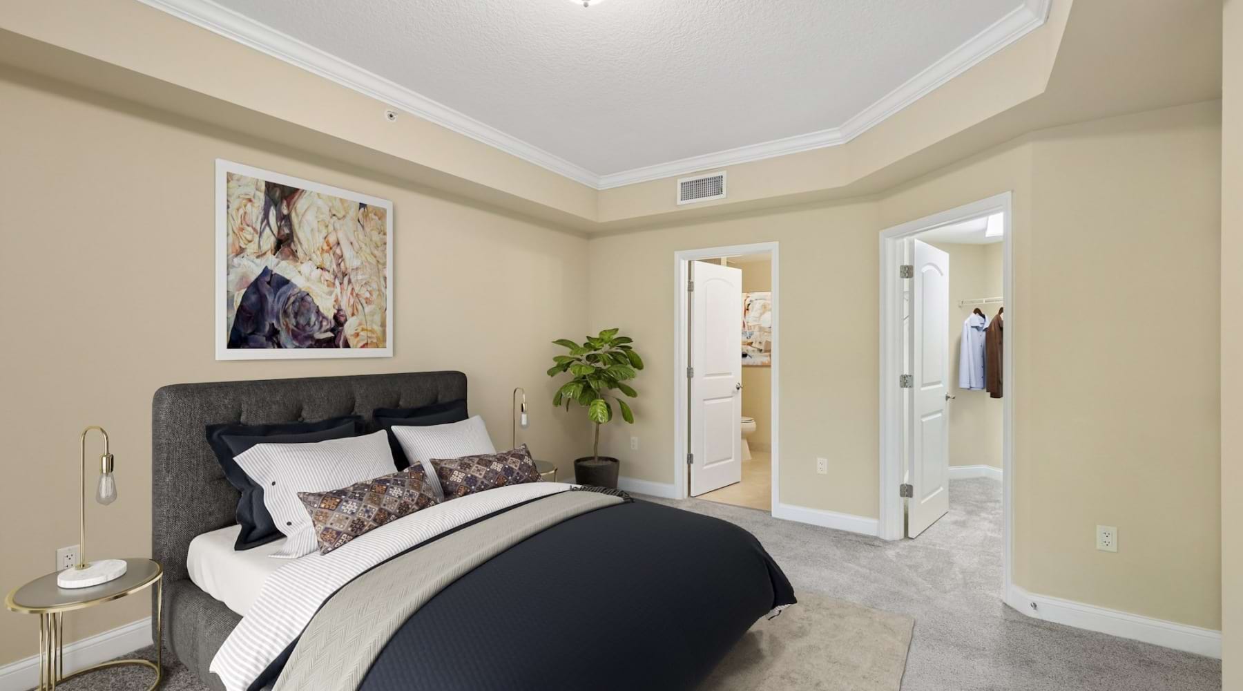 a bedroom with a bed and a plant