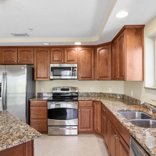 a kitchen with wooden cabinets