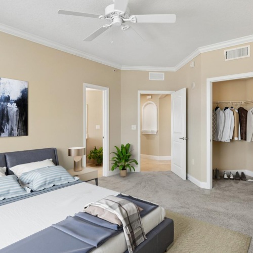 a bedroom with a bed and a fan